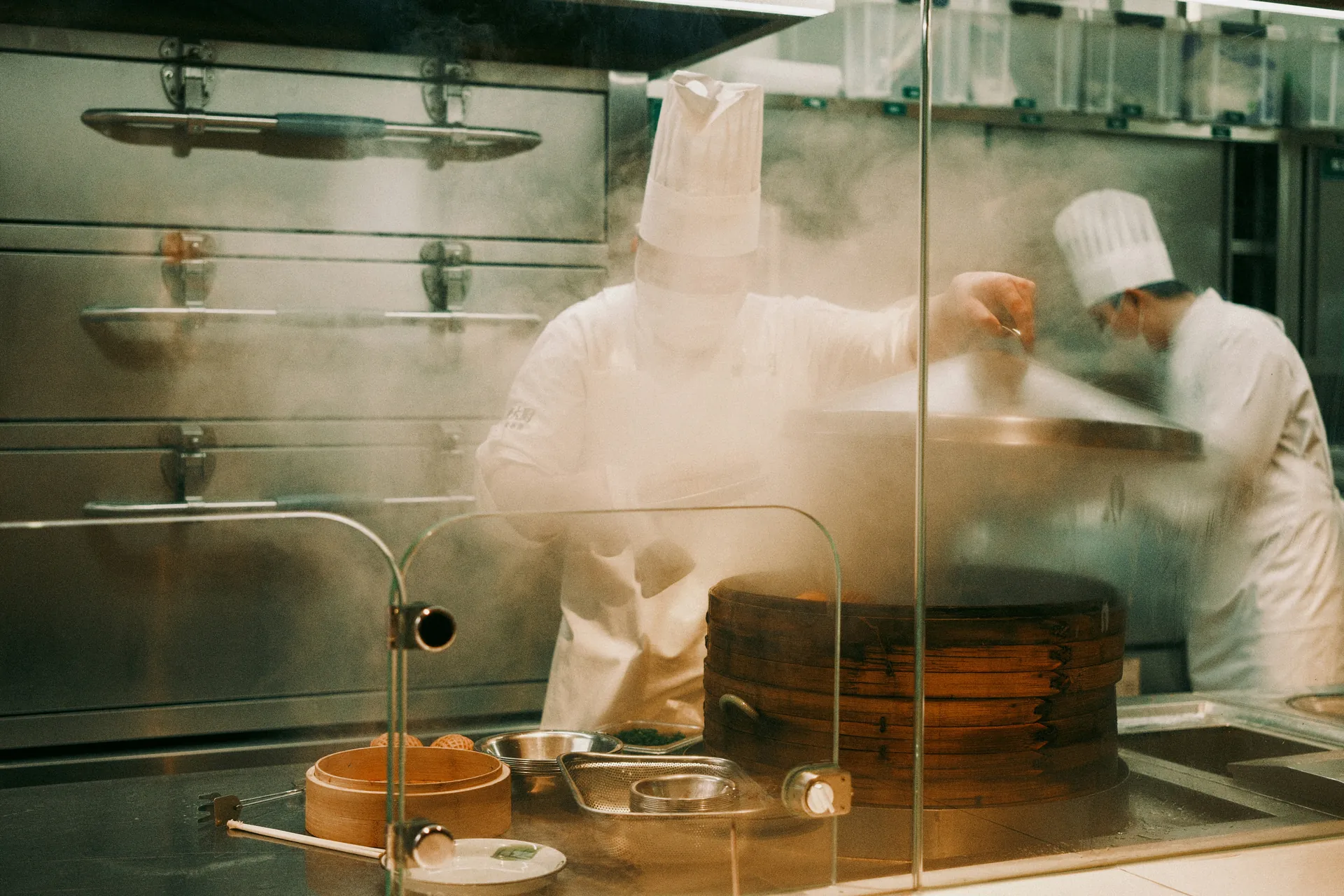 Illustratie van een chef-kok die wokt boven een fornuis, met stoom en een schaal